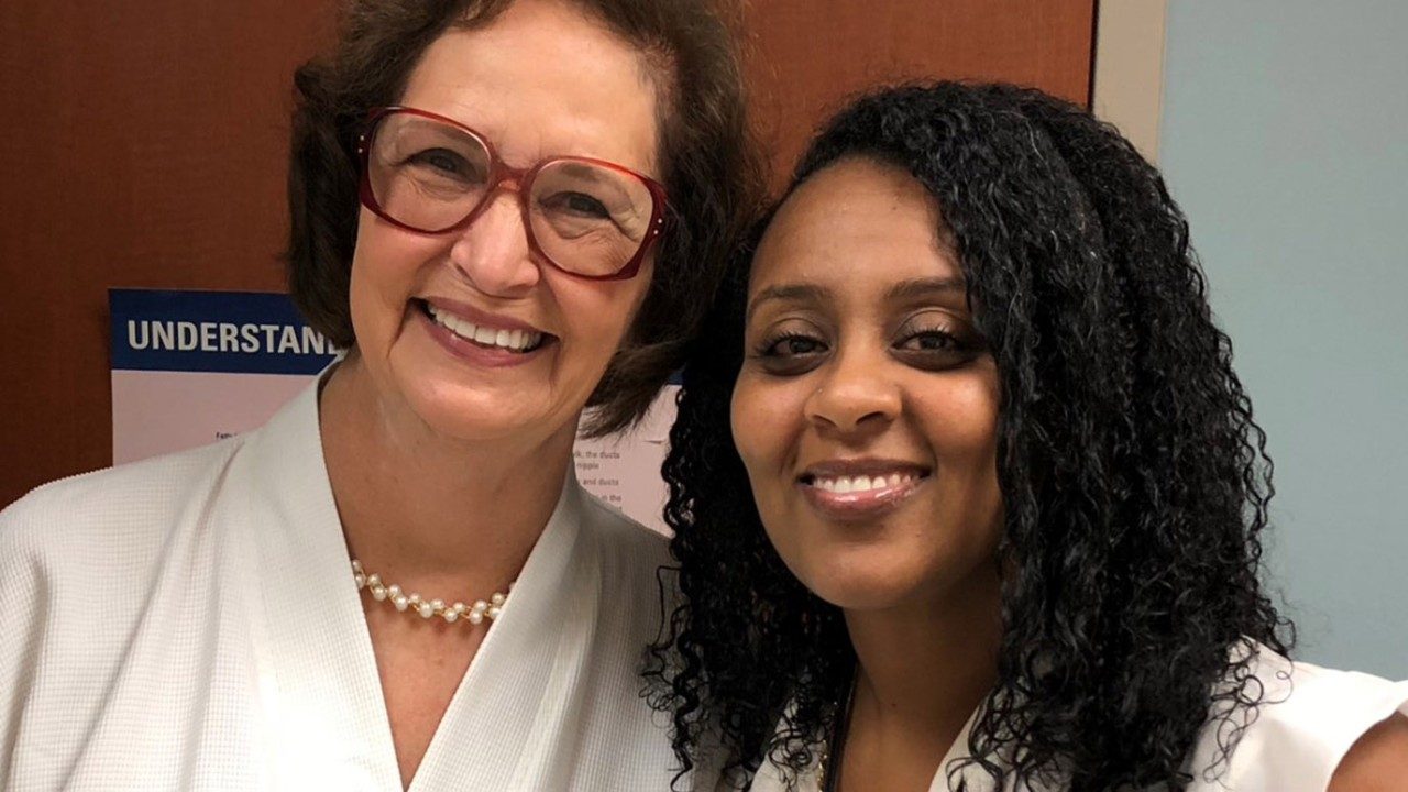 Mesothelioma survivor Christie Woodfin poses with Mediget Teshome, M.D.