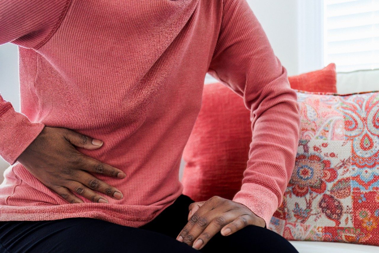 Woman with abdominal pain holding her side